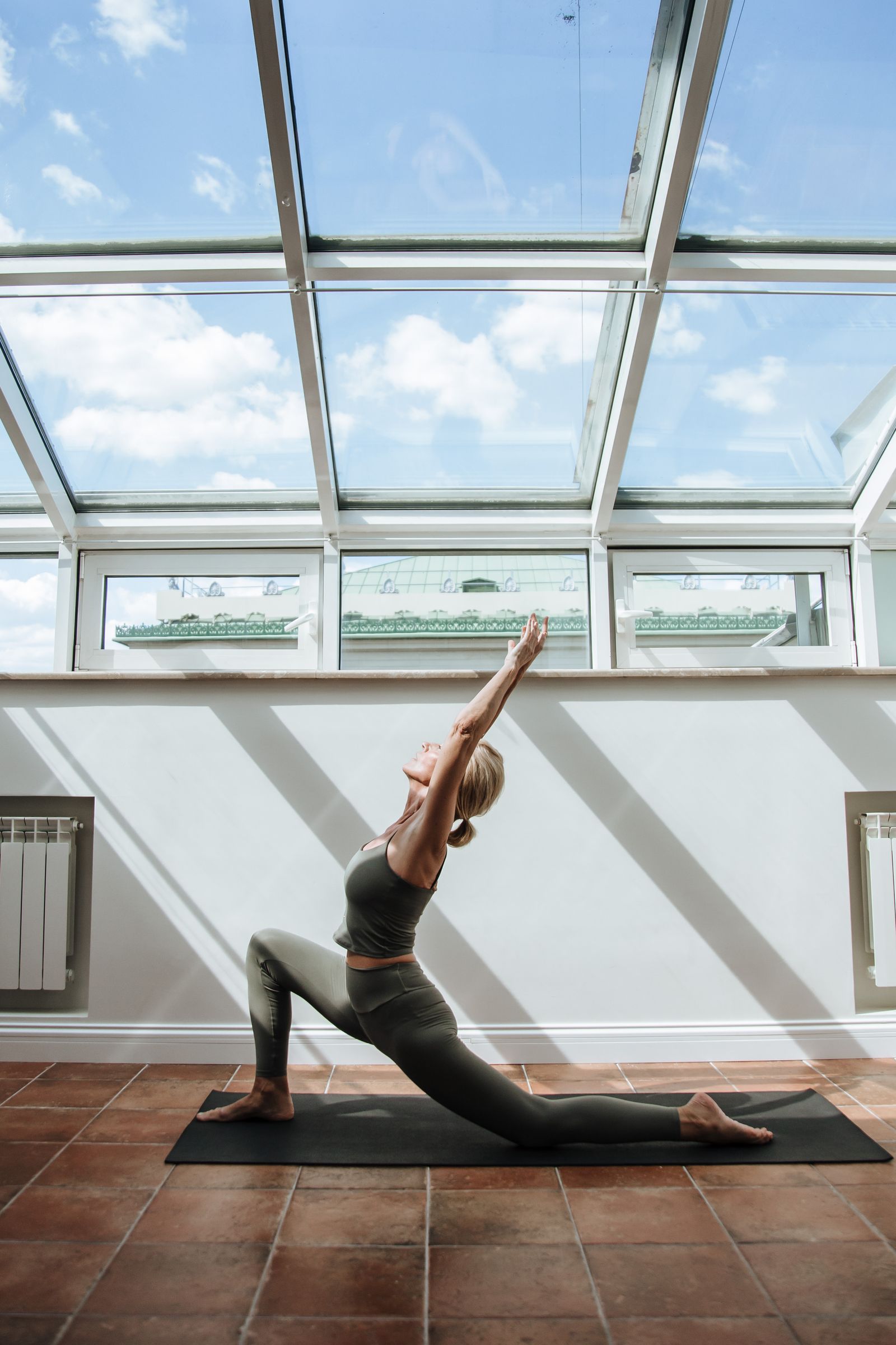 An adult taking time for gentle movement in a bright setting
